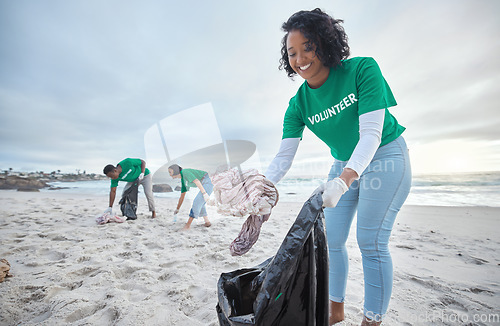 Image of Teamwork, trash and recycling with woman on beach for sustainability, environment and eco friendly. Climate change, earth day and nature with volunteer and plastic for help, energy and pollution