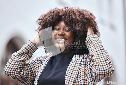 Image of Black woman, portrait smile and afro hairstyle for fashion in city travel, trip or outdoor journey. Happy African American female touching stylish curls and smiling in happiness for traveling in town