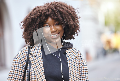 Image of Black woman, portrait and smile with earphones in city, urban town and Kenya. Happy plus size african female listening to music, radio and audio podcast with natural afro, happiness and relax outdoor