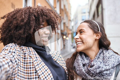 Image of Selfie, travel and laughing in the city with a woman friends outdoor for tourism or adventure overseas. Photograph, tourist or laughter with a happy female and friend joking in an urban town