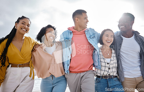 Image of Diversity, happy and friends walking at the beach for holiday, vacation and bonding on sky background space. Men, smile and women group relax at the sea, laugh and cheerful on an ocean trip in Miami