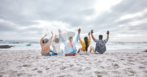 Image of Diversity, hands up or friends on beach sand to relax on holiday, vacation bonding in nature together. Back view, men and women group relaxing at sea enjoy traveling on ocean trips in Miami, Florida