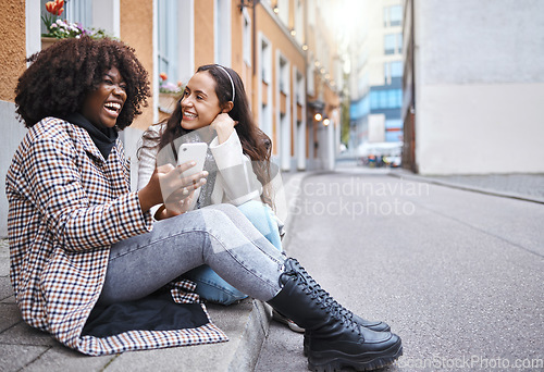 Image of Friends, city and women with phone for social media, conversation and connection on London street. Communication, internet and happy black woman and girl on smartphone laugh for meme, website and app