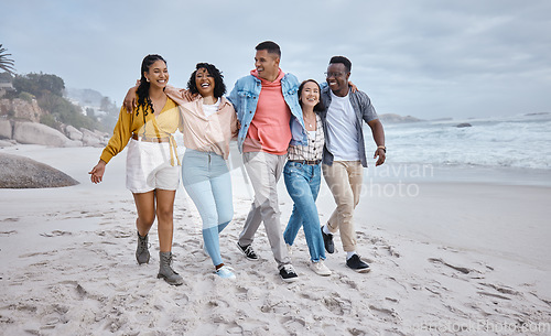 Image of Happy, diversity and friends walking at the beach for holiday, vacation and people bonding on travel. Men, smile and women group relax at the sea, laugh and cheerful on an ocean trip in Miami