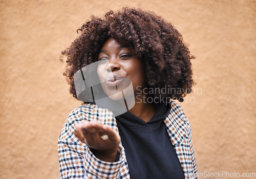 Image of Smile, flirt and black woman blowing a kiss for love and romance with urban fashion. Girl with hands, lips and kissing air, cute and fun celebration of romantic freedom and flirting with happy youth.