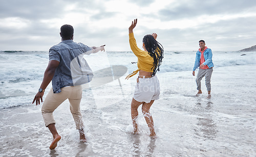 Image of Dance, water or crazy friends at a beach to relax on holiday vacation bonding in nature together in Bali. Funny, excited men and happy women group dancing at sea enjoy traveling on ocean trips