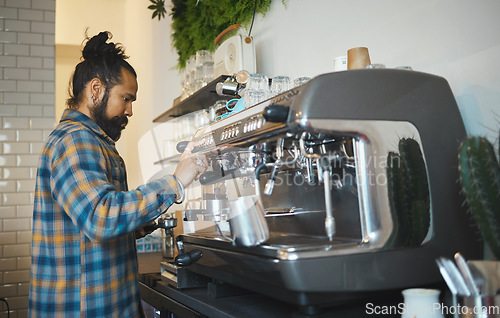 Image of Cafe, startup and service with a man barista behind the counter to prepare a drink. Coffee shop, kitchen and waiter with a male working in a restaurant as an entrepreneur or small business owner