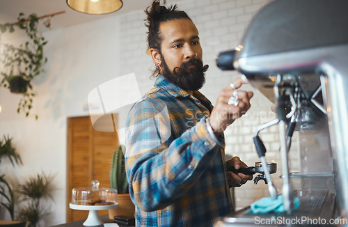 Image of Man in cafe, barista work machine and create drink with focus and small business, workflow and process. Espresso, latte or cappuccino production, busy server in coffee shop and professional