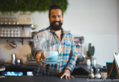 Image of Cafe, serving and man barista with a coffee for a customer in his small business restaurant. Happy, smile and male waiter or server giving a cup of cappucino, latte or espresso in his cafeteria shop