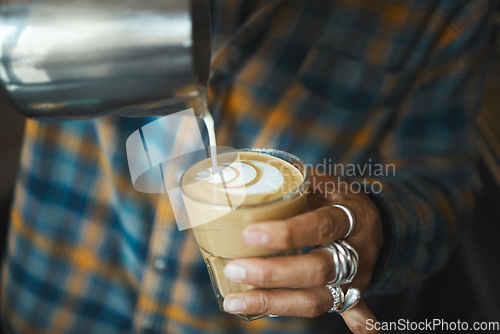 Image of Latte art, coffee and barista hand with process, workflow and production with drink and working in cafe. Creative, man drawing with milk foam and hospitality with service and beverage closeup