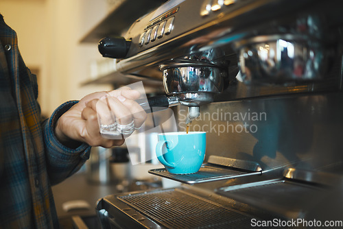 Image of Coffee shop machine handle, hand of barista brewing espresso in restaurant and closeup of hot water beverage in cafe. Caffeine drink in mug, person holding tool on morning in kitchen and breakfast