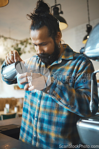 Image of Barista man, coffee shop and milk for drink service at small business with focus, care or experience. Young entrepreneur, cafe and expert with latte, cappuccino or tea for energy, health and wellness