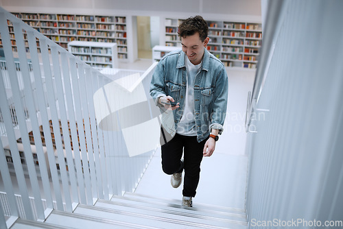 Image of Staircase, university or man with phone in library for research, communication or blog news. Book, education or happy student on smartphone for scholarship networking, social media or online content