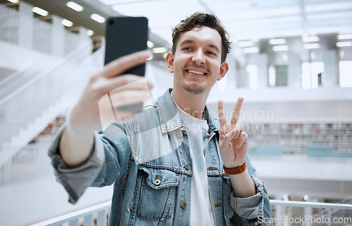 Image of Library, selfie and university man with peace sign for lifestyle update, social media or blog post with happy education. Research, study and phd student or person with emoji sign for profile picture