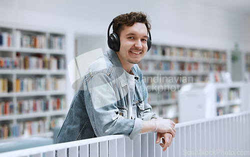 Image of Headphones, library and student portrait for university, college or campus listening to music in study education. Research, learning and bookshelf with happy person or man on audio technology podcast