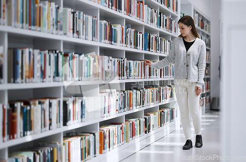 Image of Woman in library, student search for book and research project, reading with education and learning at university campus. Knowledge, story and fiction with textbook, study and browsing bookshelf