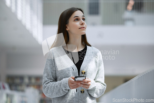 Image of Social media, education or woman with phone in library for research, communication or blog news. Thinking, university or student on smartphone for scholarship networking, website or online content