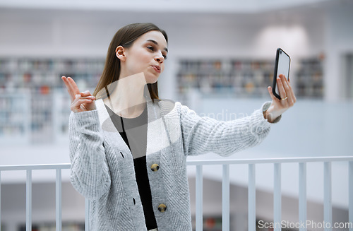 Image of Selfie, library and woman with peace sign for social media, influencer blog post or studying update for gen z lifestyle. Emoji hands person or student profile picture in university, campus or college