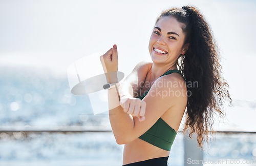 Image of Fitness, stretching and portrait of woman at beach for running, exercise and cardio or wellness, sport and body. Face, stretch and workout run by girl at ocean training, happy or warm up routine