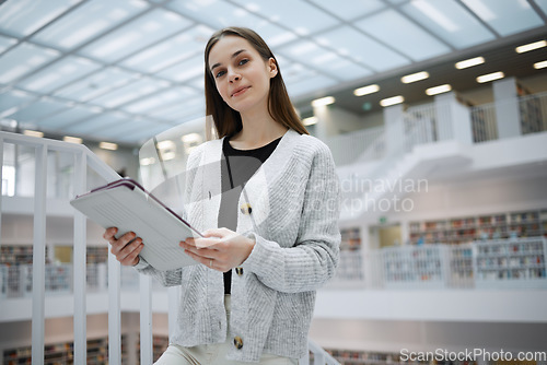 Image of University, student portrait or woman with tablet in library for research, education or learning. Bookshelf, smile or girl on tech for scholarship, search or planning school project at collage campus