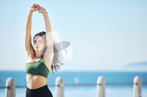 Image of Workout, stretching and exercise by woman at beach for run, sports and cardio on blue sky mockup. Mindset, stretch and fitness by girl at ocean for training, calm or relax, warm up or routine