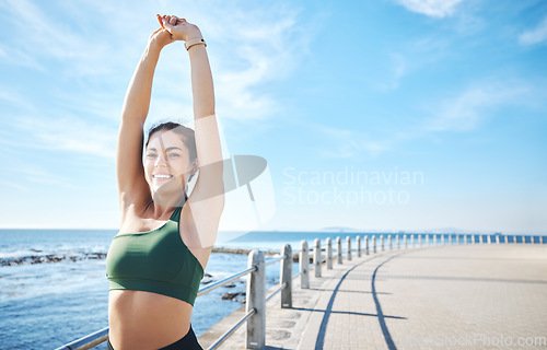 Image of Fitness, woman and stretching arms at the beach for yoga, exercise or cardio workout outdoors. Portrait of happy female runner in warm up arm stretch with smile for exercising or training on mockup