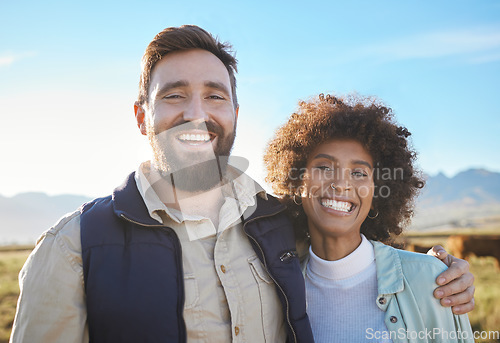 Image of Smile, cow and portrait of interracial couple on farm for agriculture, partnership or growth. Teamwork, animal and hug with man and black woman in grass field for sustainability, agro or environment