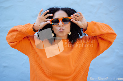 Image of Fashion, sunglasses and black woman with kiss face, summer style and beauty with hairstyle on blue background. African American model hands with designer brand frame and trendy, stylish and pose