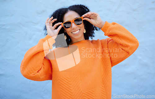 Image of Fashion portrait, sunglasses and black woman isolated on blue background gen z, youth or trendy clothes. Happy person or beauty model in confidence, vision style and orange color on brick wall mockup