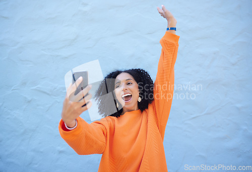 Image of Black woman excited in selfie, smartphone and success with cheers and happiness on blue background. Influencer with social media, content creation with live streaming mockup and online achievement