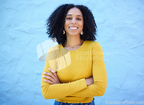 Image of Proud, portrait and black woman in studio on mockup, space and blue background for advertising. Face, smile and girl relax on backdrop, cheerful and confident, relax and posing inside on copy space