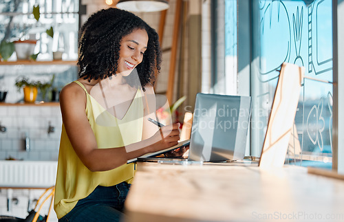 Image of Black woman, notebook and writing in cafe, laptop planning or remote worker of freelance research in restaurant. Happy female in coffee shop, notes and computer technology for blog on social network