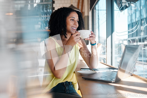 Image of Window, laptop and coffee shop with a black woman blogger drinking a beverage during remote work. Internet cafe, freelance and startup with an attractive young female working in a restaurant