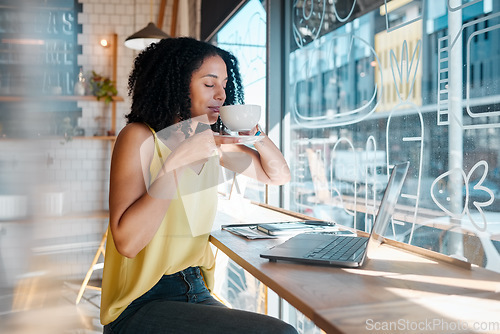Image of Window, laptop and internet cafe with a black woman blogger smelling a beverage during remote work. Coffee shop, freelance and startup with an attractive young female working in a restaurant