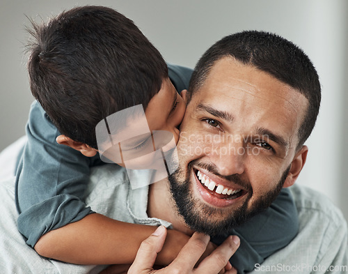 Image of Love, portrait and kid kissing his father while embracing and relaxing in the living room at family home. Happiness, smile and young man hugging and bonding with boy child with care and in house.