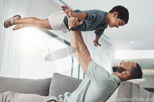 Image of Relax, smile and lifting with father and son on sofa of living room for bonding, playful and support. Wellness, game and strong with dad and child in family home for care, quality time and happy