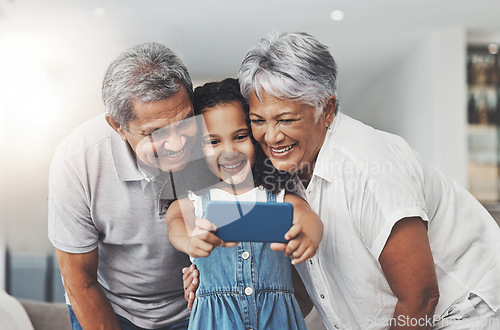 Image of Love, happy and girl taking selfie with her grandparents in the lounge of modern family home. Happiness, smile and excited child taking picture with grandmother and grandfather at a house in Mexico.