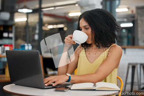 Image of Coffee, internet cafe and laptop with a black woman blogger doing research while doing remote work. Restaurant, freelance and startup with a female entrepreneur working on her small business blog