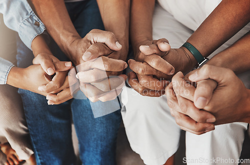 Image of Family, hands and prayer in home for love, support and faith or hope in house. Praying religion, worship and group of people pray to God, holy spirit or Jesus for peace, praise and spiritual wellness