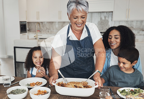Image of Grandmother, family home and kids at table for food, lunch or celebration with love, care and happiness. Black people, senior woman and children with dinner, party and happy for bonding in kitchen