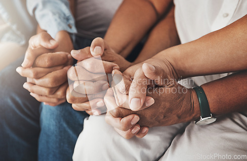 Image of Family, holding hands and prayer in home for love, support and faith or hope in house. Praying religion, worship and group of people pray to God, holy spirit or Jesus for peace or spiritual praise.