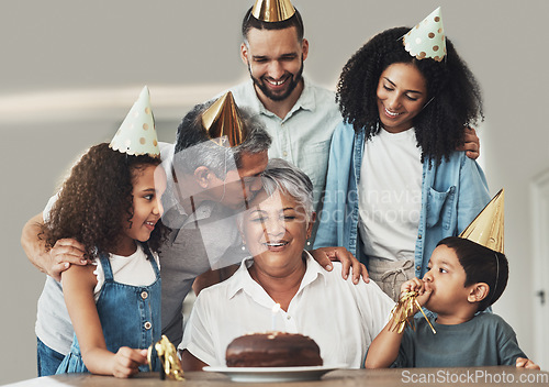 Image of Family, birthday celebration and senior woman at a table with a cake, love and care in a house. Children, parents and grandparents together for a party to celebrate excited grandma with dessert