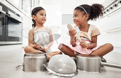 Image of Girl kids playing house with pots as drums, happy and care free at family home, make believe with music and fun. Noise, metal and children on floor, play date together and fantasy with imagination