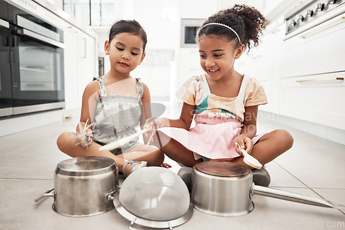 Image of Girl children are playing house, pots as drums and happy, care free at family home and make believe with music fun. Noise, metal and kids on floor, play date together and fantasy with imagination