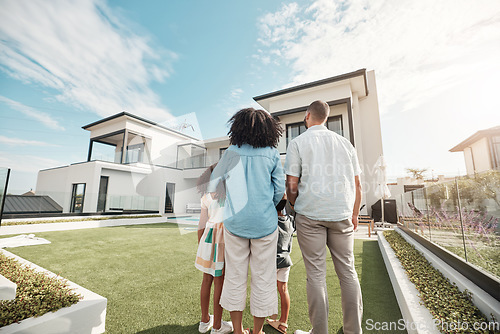 Image of Love, new house and family in their backyard together looking at their property or luxury real estate. Embrace, mortgage and parents with their children on grass at their home or mansion in Canada.