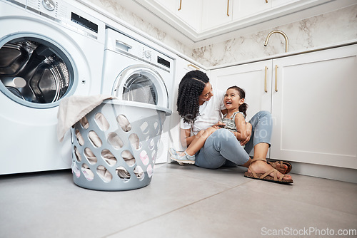 Image of Mom, girl kid and basket by washing machine on floor for cleaning, bonding and comic laugh in house. Laundry, mother and daughter with happiness, love and care in family home with happy smile for hug