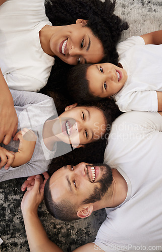 Image of Above, family and portrait with children and parents on a floor, happy and relax while bonding in their home. Love, mother and kids with father on the ground for fun, laugh and playing in their house