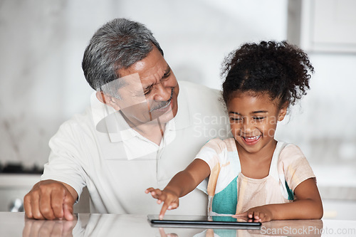 Image of Learning, grandfather and girl with tablet in home, playing online games or educational app. Family bonding, touchscreen or care of happy grandpa teaching child how to use digital technology in house