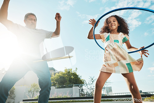 Image of Grandfather, girl child and family hula hoop in city, having fun and bonding together outdoors. Love, portrait and low angle of grandpa and kid playing with hoops toy, dance and enjoying quality time