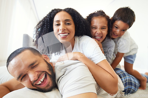 Image of Happy family, selfie and portrait with children and parents relax, play and have fun in bed at home in the morning. Face, smile and kids waking up with mother and father for photo while bonding